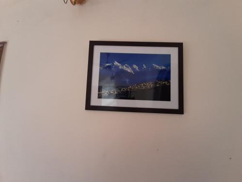 a picture of a mountain on a wall at Sukoon.Homestay in Rājpur
