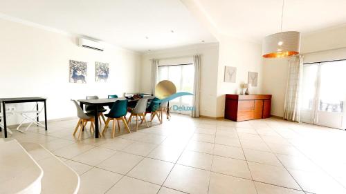 a living room with a dining room table and chairs at Villa Clara Premium by Sunny Deluxe in Albufeira