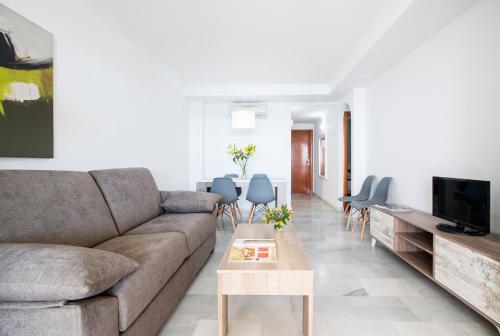 a living room with a couch and a table at Pierre & Vacances Altea Beach - Port in Altea