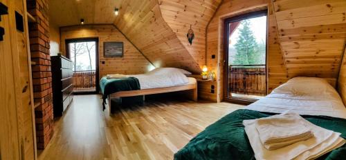 Postel nebo postele na pokoji v ubytování Dom Pod Leśniczówką