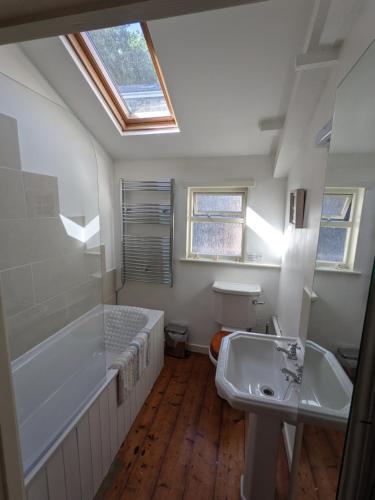 ein Badezimmer mit Badewanne und Waschbecken in der Unterkunft Traditional Fisherman's Cottage with 3 bedrooms in Mousehole