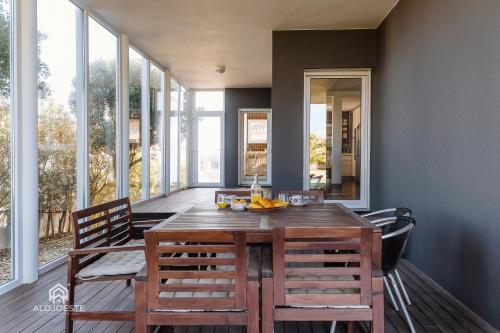 a dining room with a wooden table and chairs at Villa da Gama - Santa Cruz in Santa Cruz