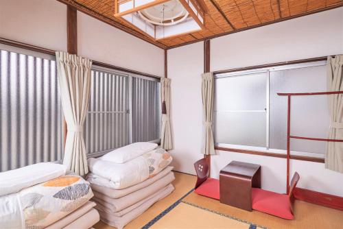 Postel nebo postele na pokoji v ubytování Nikko Guesthouse Sumica