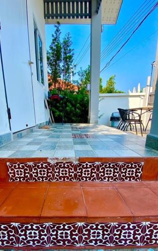 a porch with a pattern on the floor of a house at Origin hua hin poolvilla in Hua Hin