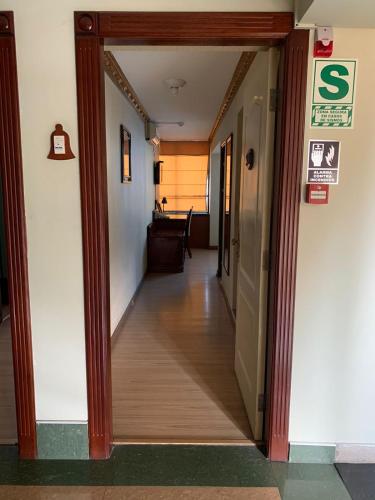 an open hallway with a hallway leading to a room at Hotel Oro Inn in Lima