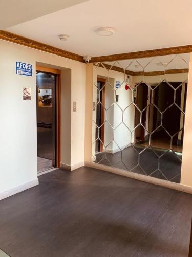 an empty room with a wall of glass at Hotel Oro Inn in Lima