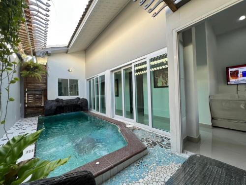 a swimming pool in the middle of a house at Origin hua hin poolvilla in Hua Hin