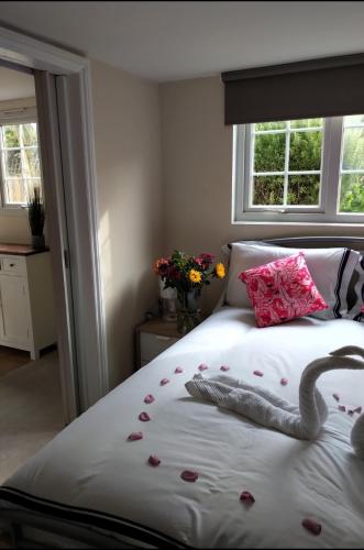 a bedroom with a bed with a swan on it at Summer House at Percy Villas in Kent