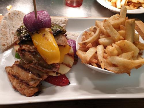 a plate of food with a sandwich and french fries at The Harbour Moon in Looe