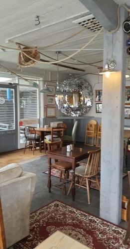 a dining room with a table and chairs at The Harbour Moon in Looe