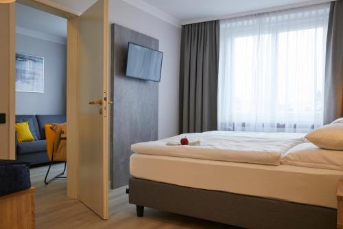 a hotel room with a bed and a window at Hotel Concorde in Munich