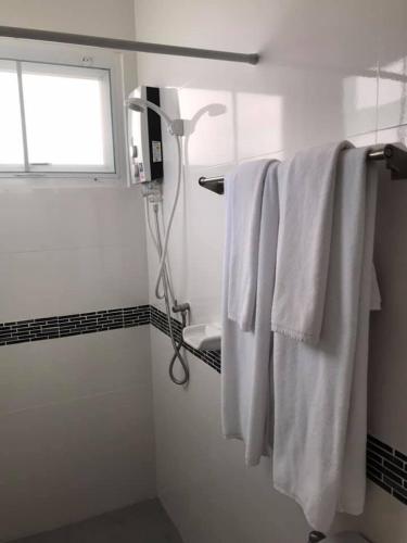 a bathroom with white towels on a rack and a window at Origin hua hin poolvilla in Hua Hin