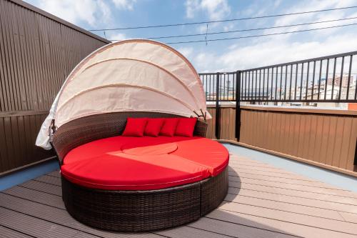 a round bed on a balcony with a cover at Hotel kiki in Osaka