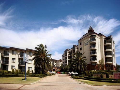 a city street with buildings and palm trees on the side at Great Eastern Motor Lodge in Perth
