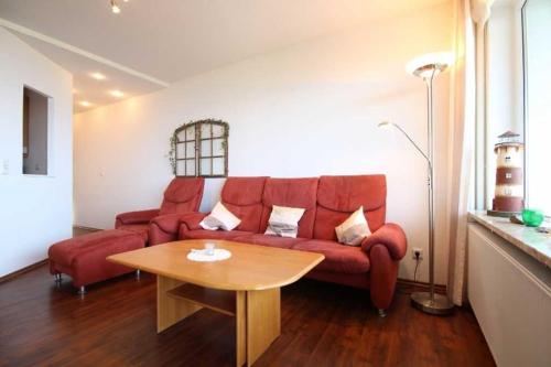 クックスハーフェンにあるPacific Wohnung 41のリビングルーム(赤いソファ、テーブル付)