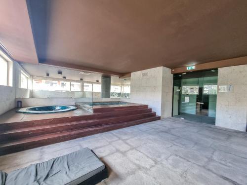 an empty lobby with a jacuzzi in a building at Foz Palace Spa Luxury Residence in Portimão