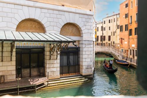a gondola in a canal next to a bridge at Ca' Maria Callas in Venice