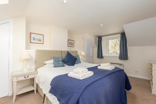 a bedroom with a bed with towels on it at Melfort Village in Oban