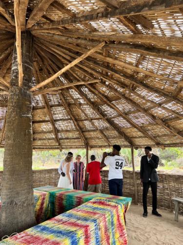 a group of people taking pictures in a barn at Nemasu Eco-lodge in Gunjur