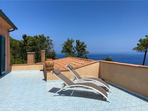 a pair of lounge chairs sitting on a patio at Residence Intur in Marciana Marina