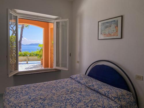 a bedroom with a bed and a window at Residence Intur in Marciana Marina