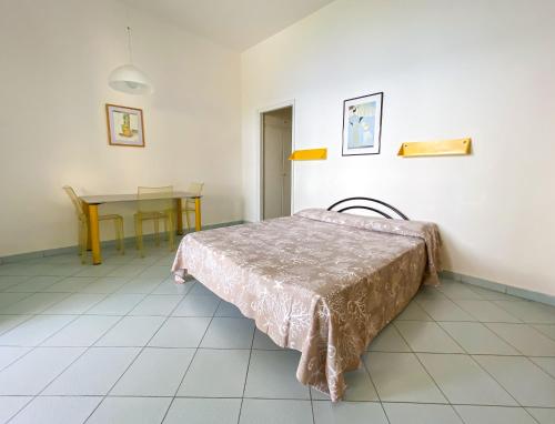 a room with a bed and a table in it at Residence Intur in Marciana Marina