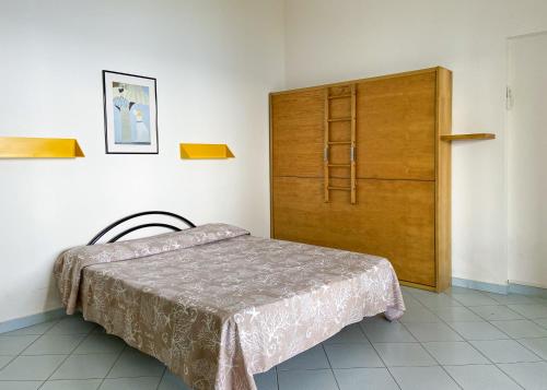 a bedroom with a bed and a wooden cabinet at Residence Intur in Marciana Marina