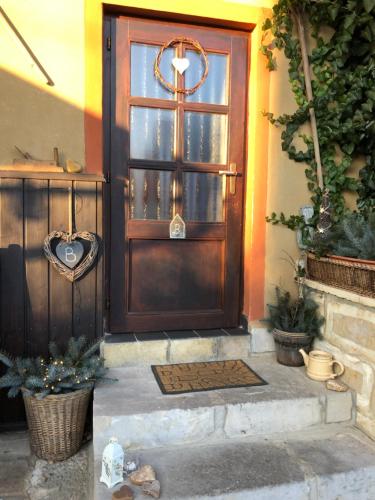 a door to a house with a cross on it at Pension Laura in Chřibská