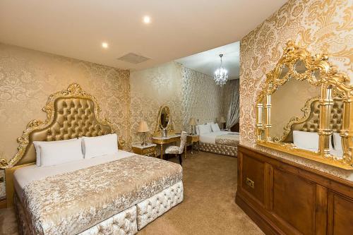 a bedroom with a large bed and a large mirror at The Dixie Dean Hotel in Liverpool