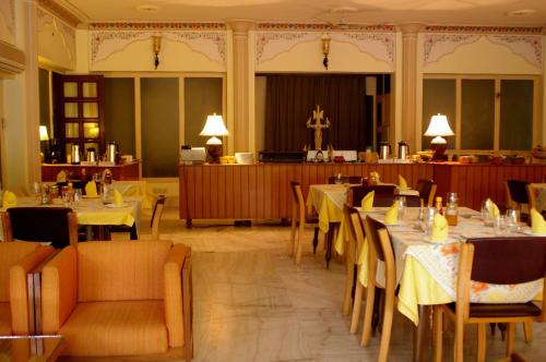 a dining room with tables and chairs and a church at Hotel Meghniwas in Jaipur