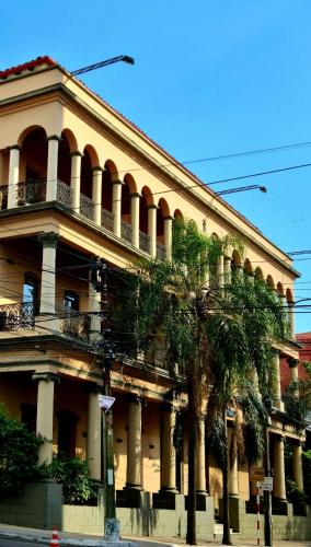 a building with palm trees in front of it at Asuncion Palace in Asuncion