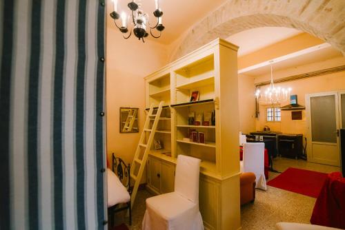 a living room with a book shelf and a desk at Palazzo Romani Adami in Fermo