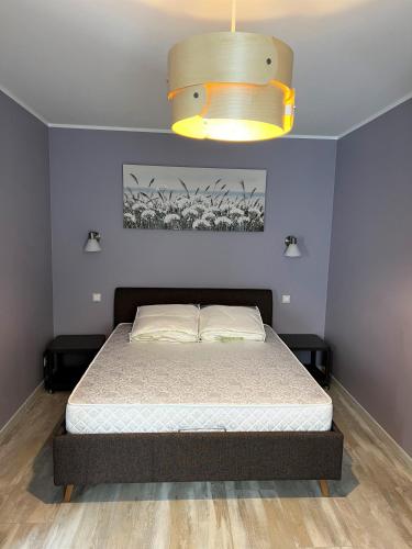 a bedroom with a bed and a large light at Classic and calm city center in Rīga