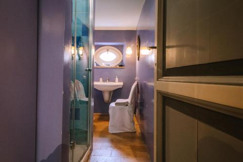 a small bathroom with a sink and a mirror at Palazzo Romani Adami in Fermo