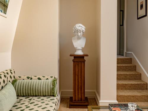 a statue of a bust on a pedestal in a living room at Saint James Paris in Paris