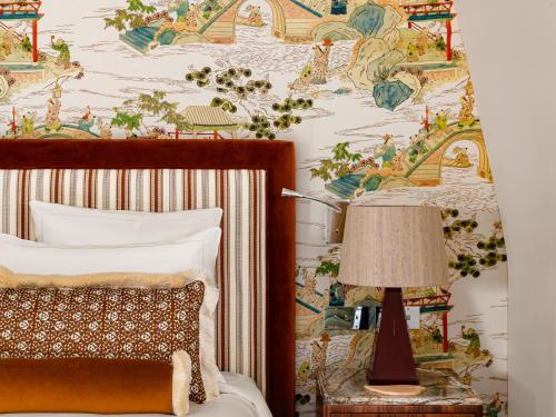 a bedroom with a bed and a wall with a wallpaper at Saint James Paris in Paris