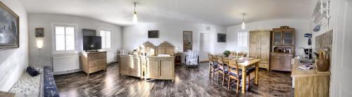 a kitchen with wooden cabinets and a table in a room at Pension Laura in Chřibská