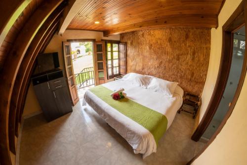 a bedroom with a bed in a room with a window at San Agustin Internacional Hotel in San Agustín