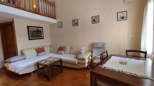 a living room with a couch and a table at Gudelj Apartments in Perast
