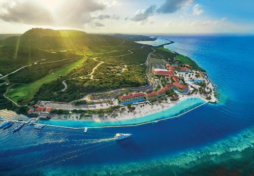 an island in the ocean with a boat in the water at Sandals Royal Curacao All Inclusive Couples Only in Nieuwpoort