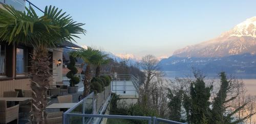 a balcony of a house with a view of a mountain at Hotel Brienzersee in Ringgenberg