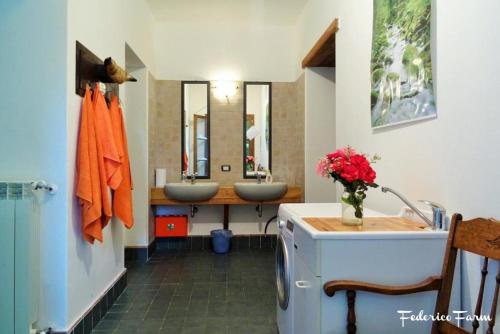 a bathroom with two sinks and two mirrors at Camping Grondola - FedericoFarm in Pontremoli