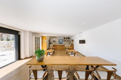 a dining room with a large wooden table and chairs at Casa Vieira Lobo in Arouca