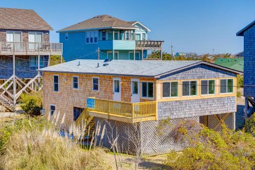 a large house with a balcony on a beach at Walk the Plank 876 in Hatteras