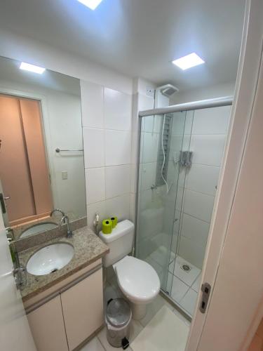 a bathroom with a toilet and a sink and a shower at São Luís com conforto e praticidade in São Luís