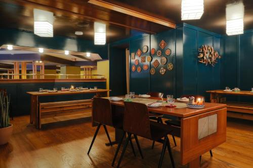 a dining room with blue walls and a table and chairs at Freehand Los Angeles in Los Angeles