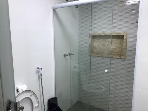 a shower with a glass door in a bathroom at ABC Apart Hotel in Brasilia