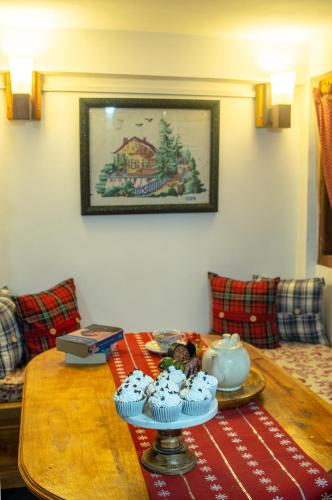 a wooden table with cupcakes on top of it at Quo Vadis Farm in Māngwa