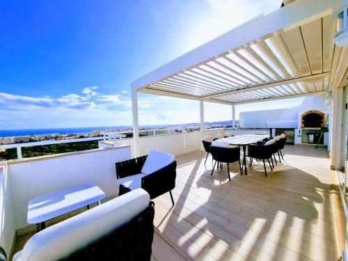 a patio with a table and chairs on a balcony at Penthouse Rentalbufeira in Albufeira