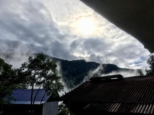 a view of a mountain with clouds in the sky at Quo Vadis Farm in Māngwa